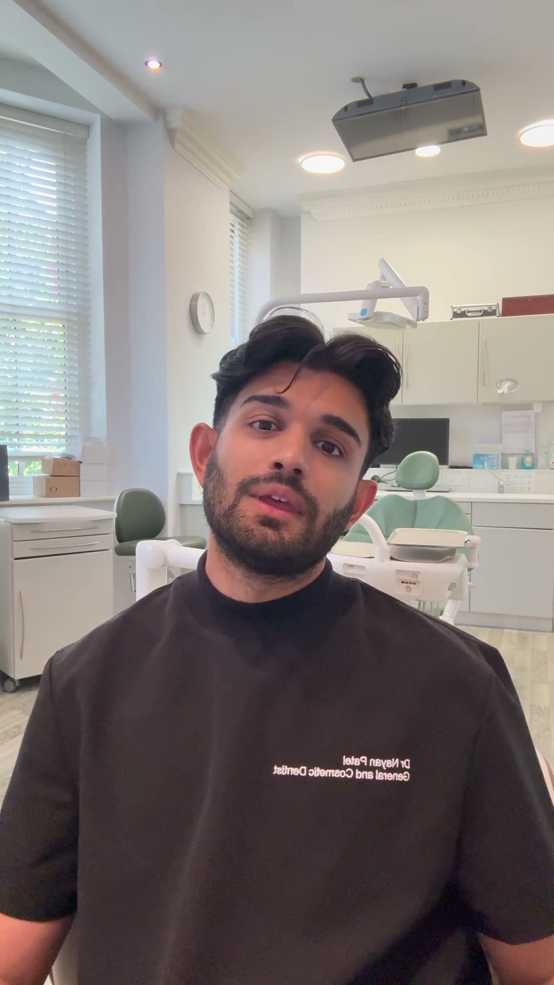 Dr. Nayan Patel hablando en su consultorio dental práctica